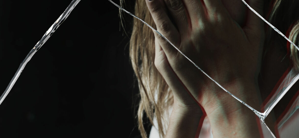 Depressed woman with cracked glass effect